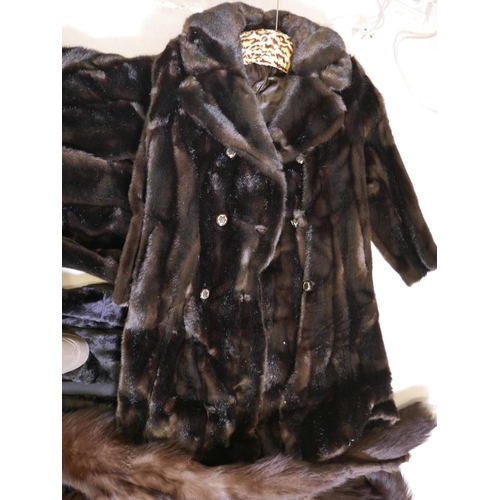 556 - Two Astraka faux fur full length coats, together with another faux fur collarless coat and a twin fo... 