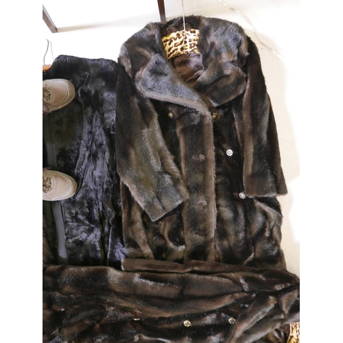 556 - Two Astraka faux fur full length coats, together with another faux fur collarless coat and a twin fo... 