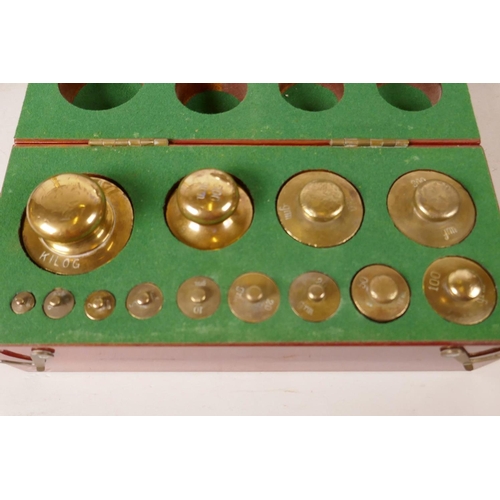 563 - Two sets of scales and a mahogany cased set of precision brass metric weights, 1kg - 1g