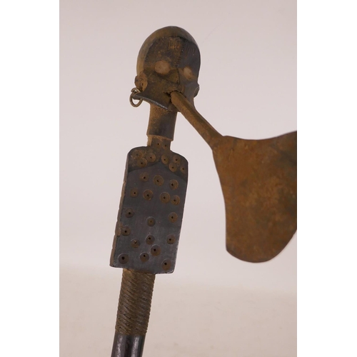 565 - An Ethnic carved wood axe with figural decoration and woven wire banding, 19½