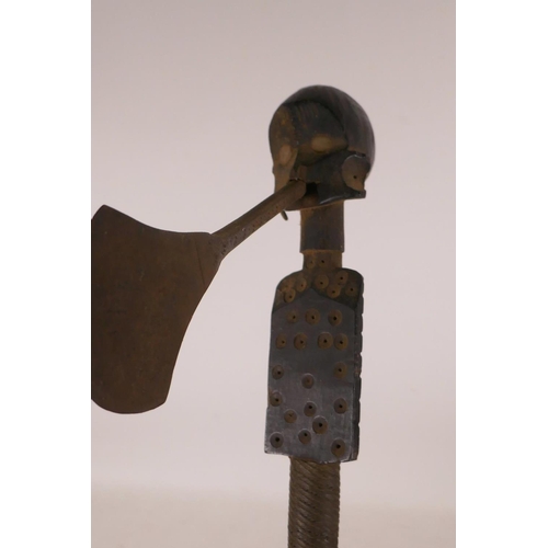 565 - An Ethnic carved wood axe with figural decoration and woven wire banding, 19½