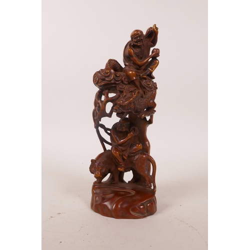 58 - A Chinese boxwood carving depicting two Lohan riding a dragon and tiger, 7