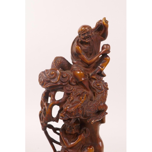 58 - A Chinese boxwood carving depicting two Lohan riding a dragon and tiger, 7