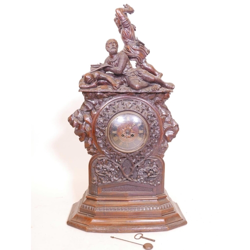 611 - A C19th Black Forest walnut bracket clock, with carved decoration of oak and acorns under a figure g... 