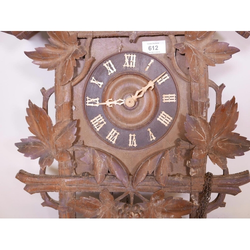 612 - A C19th Black Forest wall cuckoo clock, with carved and pierced top, pendulum and core weights, with... 