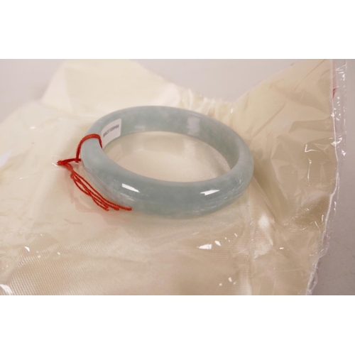 613 - A Chinese celadon jade bangle, 3