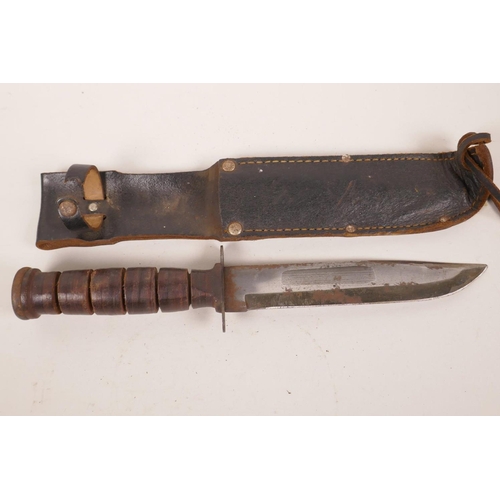 62 - A WWII dagger with compound leather handle and leather sheath, 12