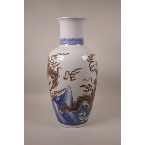 63 - A large Chinese blue and white porcelain vase decorated with a red dragon chasing the flaming pearl,... 