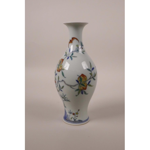 68 - A Chinese doucai porcelain vase decorated with a fruiting peach tree and bats, 6 character mark to b... 