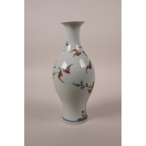 68 - A Chinese doucai porcelain vase decorated with a fruiting peach tree and bats, 6 character mark to b... 