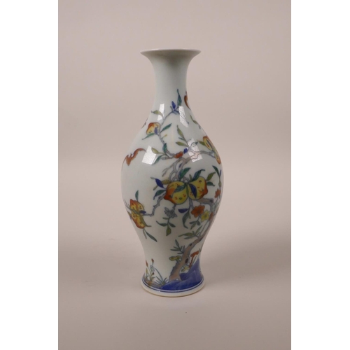 68 - A Chinese doucai porcelain vase decorated with a fruiting peach tree and bats, 6 character mark to b... 