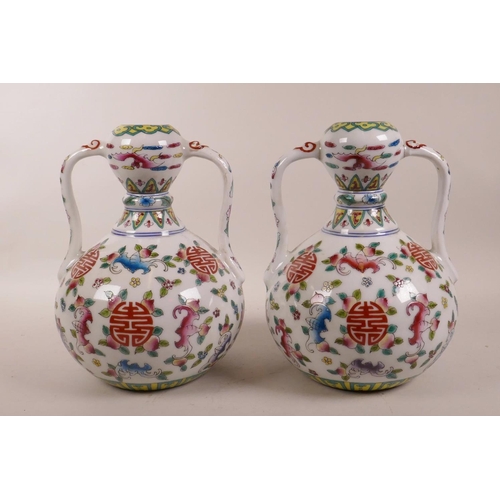 70 - A pair of Chinese polychrome porcelain garlic head shaped vases with two handles, decorated with bat... 