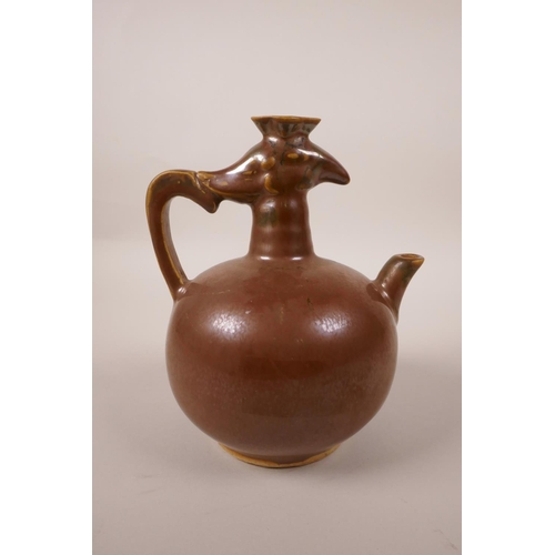 73 - A Chinese pottery wine pourer in the form of a phoenix, with a copper glaze, 5½