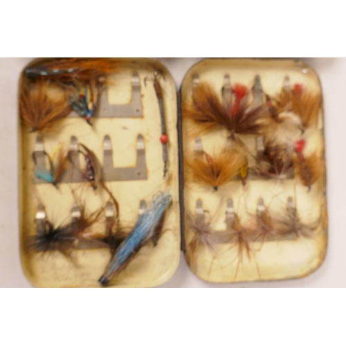 97 - A vintage Hardy Bros black metal fly box containing various flies, 5½