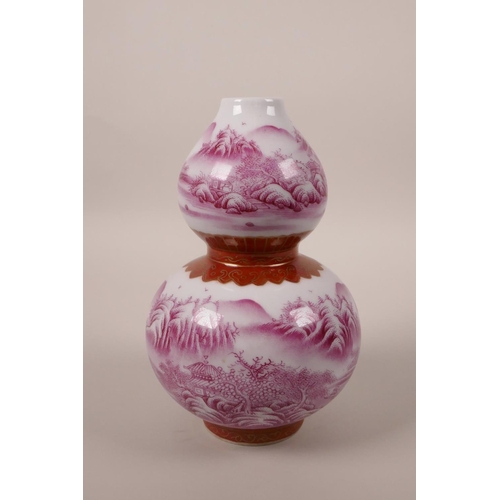 98 - A Chinese double gourd porcelain vase decorated in pink enamels depicting a riverside landscape, sea... 