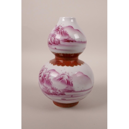 98 - A Chinese double gourd porcelain vase decorated in pink enamels depicting a riverside landscape, sea... 