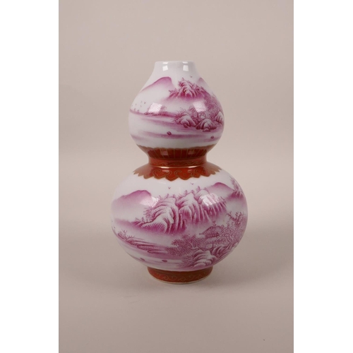 98 - A Chinese double gourd porcelain vase decorated in pink enamels depicting a riverside landscape, sea... 