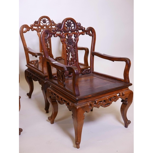 1115 - A set of four Chinese hardwood open armchairs, with carved and pierced backs and friezes, raised on ... 