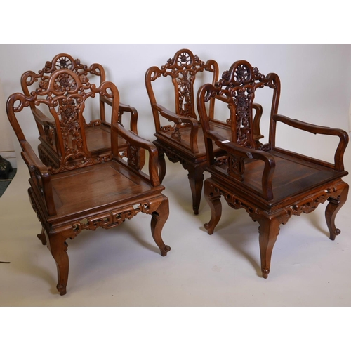 1115 - A set of four Chinese hardwood open armchairs, with carved and pierced backs and friezes, raised on ... 