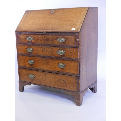 1125 - A Georgian oak fall front bureau, with fitted interior over four long drawers with original plate ha... 