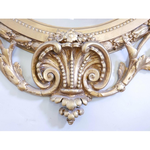 1130 - A large C19th giltwood and composition wall mirror with laurel leaf and swag decoration, 30