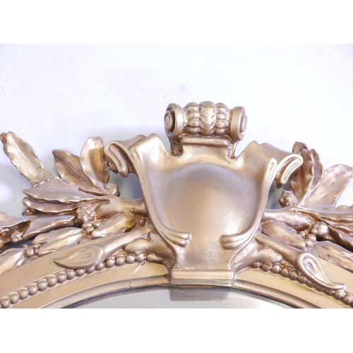 1130 - A large C19th giltwood and composition wall mirror with laurel leaf and swag decoration, 30