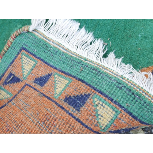 1134 - An Indian hand woven deep pile wool carpet with stylised bird decoration on a green field, 72