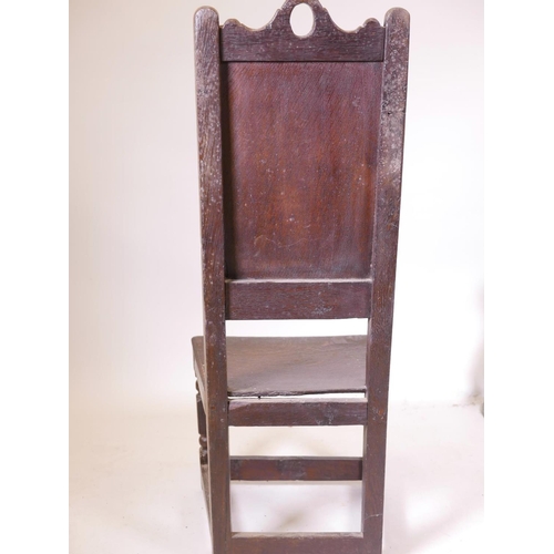 1136 - A C17th/C18th oak high back Wainscot chair with fielded panel back, 44½