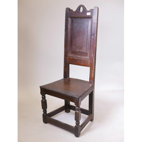 1136 - A C17th/C18th oak high back Wainscot chair with fielded panel back, 44½