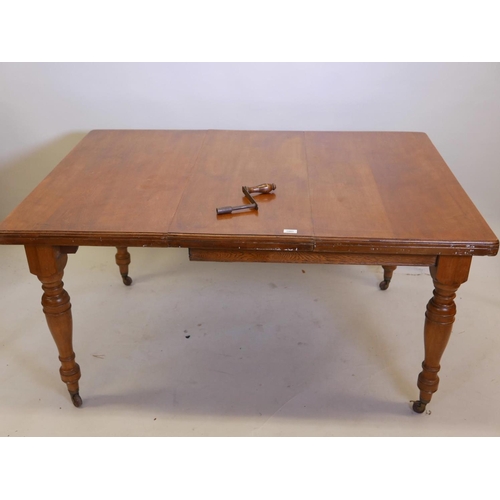 1137 - A Victorian light walnut dining table, raised on turned supports, 42