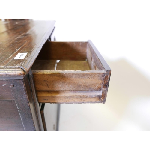 1102 - A C19th pine Lincolnshire dresser with seven drawers flanking a central cupboard, 62