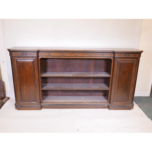 1090 - A Victorian walnut breakfront low bookcase, with ebonised and parcel gilt decoration in the Aestheti... 