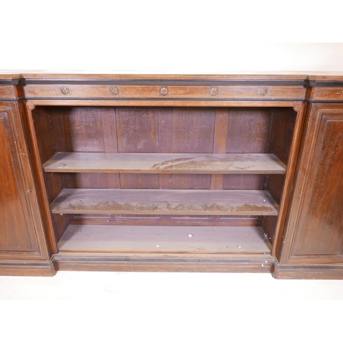 1090 - A Victorian walnut breakfront low bookcase, with ebonised and parcel gilt decoration in the Aestheti... 