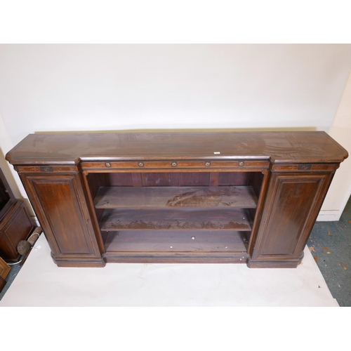 1090 - A Victorian walnut breakfront low bookcase, with ebonised and parcel gilt decoration in the Aestheti... 