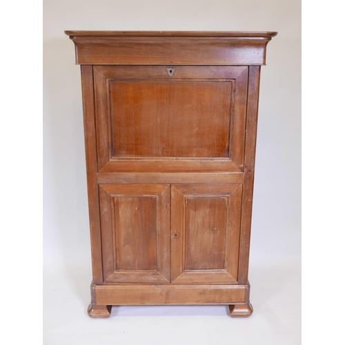 1094 - A French fruitwood secretaire à abattant, with shaped frieze drawer over a fitted fall and two cupbo... 