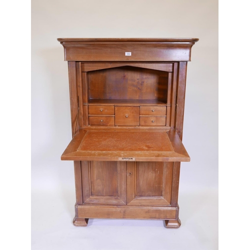 1094 - A French fruitwood secretaire à abattant, with shaped frieze drawer over a fitted fall and two cupbo... 