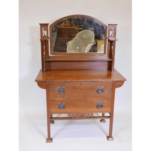 1100 - An Arts and Crafts oak dressing table in the Liberty style, 39