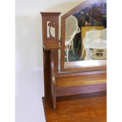 1100 - An Arts and Crafts oak dressing table in the Liberty style, 39