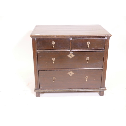 1102 - A Queen Anne oak chest of drawers, with panelled sides and plank top, and two over two drawers, rais... 