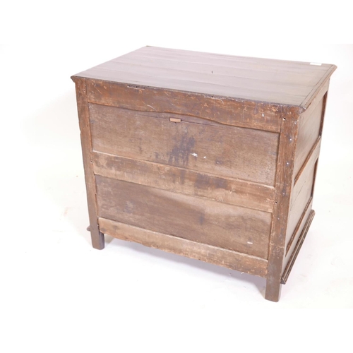 1102 - A Queen Anne oak chest of drawers, with panelled sides and plank top, and two over two drawers, rais... 