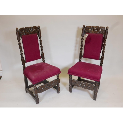 1104 - A pair of C17th/18th oak high back side chairs with carved coronets to back rail and stretcher, 44