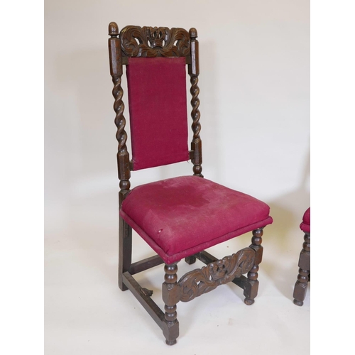 1104 - A pair of C17th/18th oak high back side chairs with carved coronets to back rail and stretcher, 44