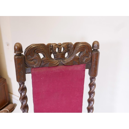 1104 - A pair of C17th/18th oak high back side chairs with carved coronets to back rail and stretcher, 44