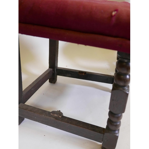 1104 - A pair of C17th/18th oak high back side chairs with carved coronets to back rail and stretcher, 44