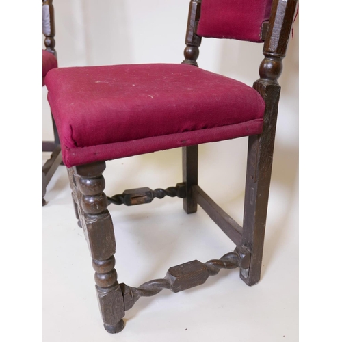 1104 - A pair of C17th/18th oak high back side chairs with carved coronets to back rail and stretcher, 44