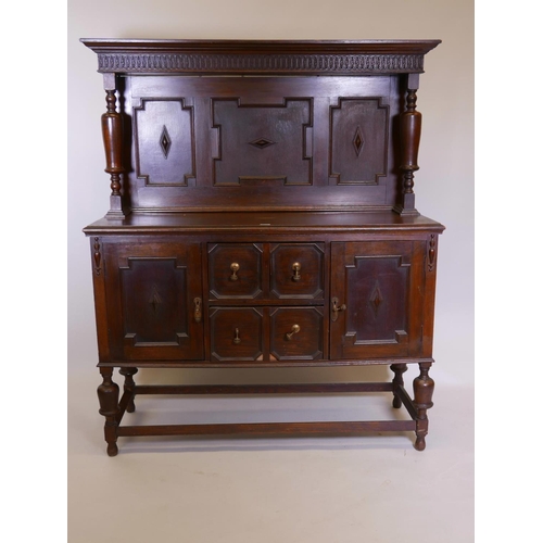 1110 - A Victorian Jacobean style sideboard with carved frieze and panelled upper section over two cupboard... 