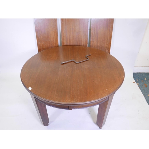 1121 - An early C20th mahogany wind out dining table with three leaves, 49