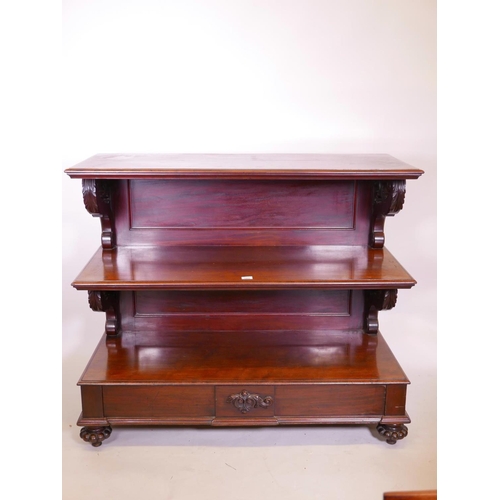 1131 - A Vicotorian mahogany three tier buffet with scrolled supports, single frieze drawer, and gadrooned ... 