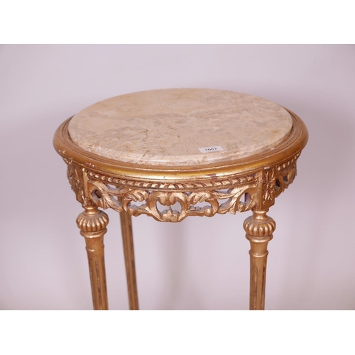 1133 - A Louis XV style giltwood occasional table with carved pierced frieze, fluted supports, pierced stre... 