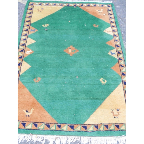 1134 - An Indian hand woven deep pile wool carpet with stylised bird decoration on a green field, 72